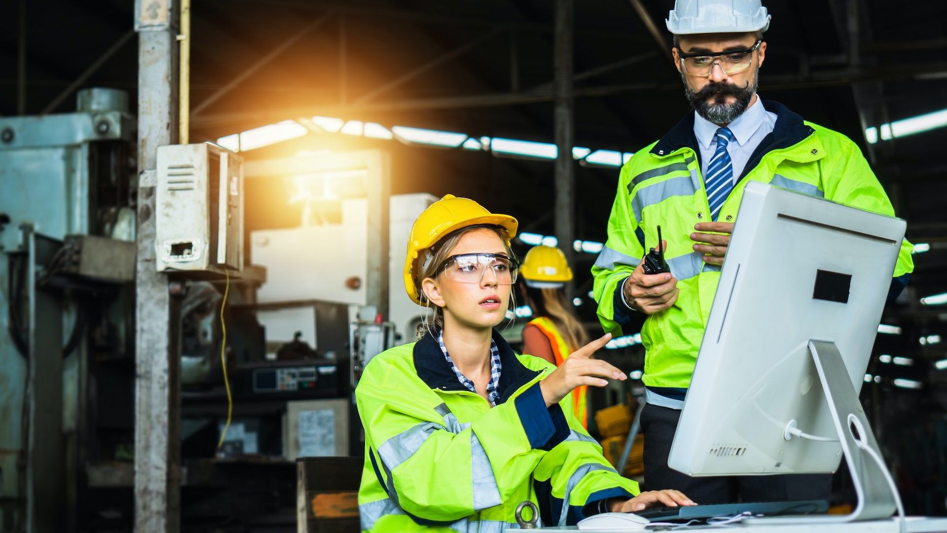 Inspector monitoring screens to control industrial operations